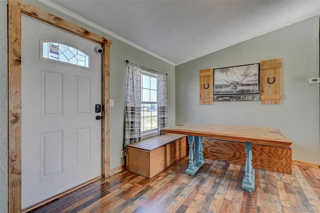 5525 S Johnson Rd, Rush, CO 80833 - entrance foyer featuring wood finished floors, crown molding, baseboards, vaulted ceiling, and a textured ceiling