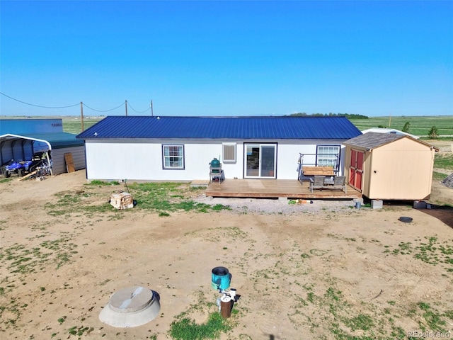 5525 S Johnson Rd, Rush, CO 80833 - view of front of home with a storage shed, a deck, an outdoor structure, and metal roof