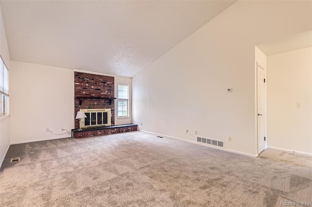 13940 E Linvale Pl, Aurora, CO 80014 - unfurnished living room featuring carpet, a fireplace, baseboards, lofted ceiling, and a textured ceiling