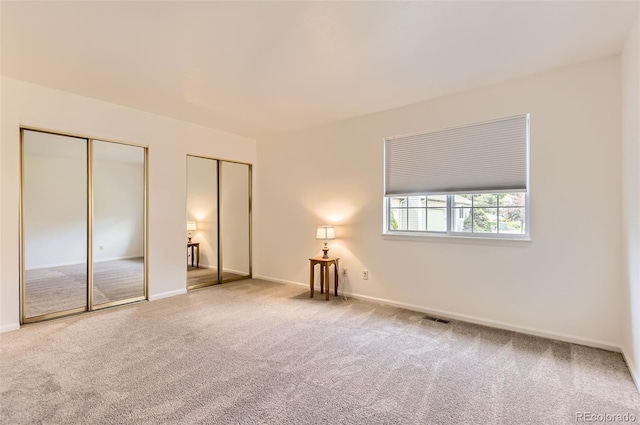 13940 E Linvale Pl, Aurora, CO 80014 - unfurnished bedroom featuring multiple closets, carpet floors, and baseboards
