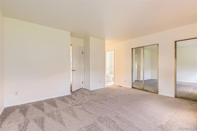 13940 E Linvale Pl, Aurora, CO 80014 - unfurnished bedroom featuring two closets, carpet flooring, baseboards, and connected bathroom