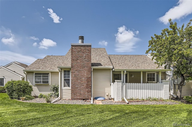 13940 E Linvale Pl, Aurora, CO 80014 - back of property with a lawn, roof with shingles, and a chimney
