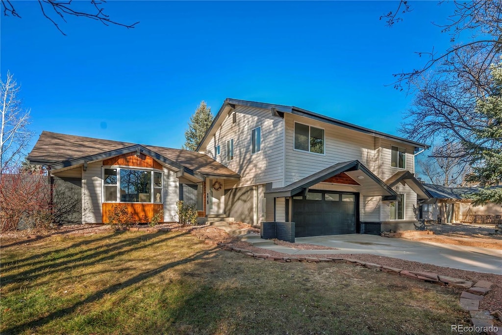 view of front facade with a front yard and a garage