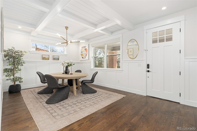 dining area with dark wood-type flooring, plenty of natural light, and beam ceiling