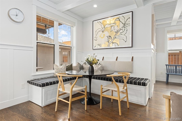 dining space with breakfast area, dark hardwood / wood-style floors, and beamed ceiling