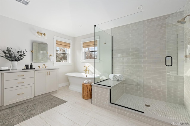 bathroom featuring tile patterned floors, vanity, and shower with separate bathtub