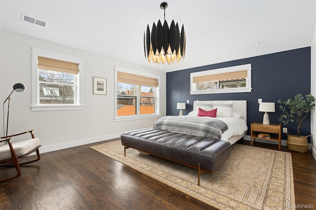 bedroom featuring dark hardwood / wood-style flooring and multiple windows