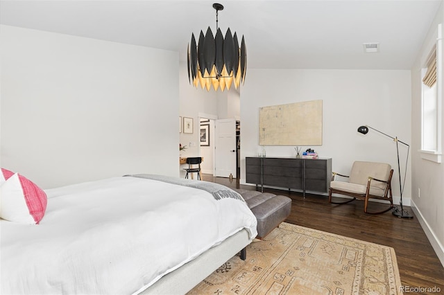 bedroom with hardwood / wood-style flooring and lofted ceiling