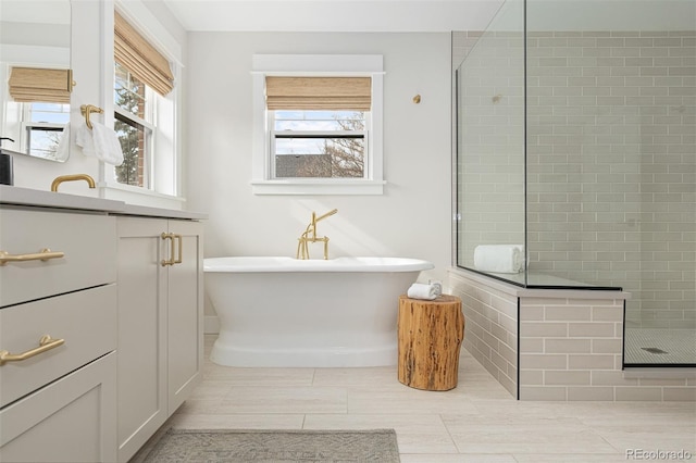 bathroom featuring vanity and shower with separate bathtub