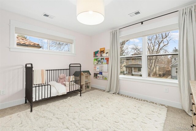 carpeted bedroom featuring multiple windows