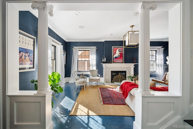 living room featuring ornamental molding, a high end fireplace, and decorative columns