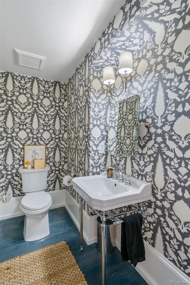 bathroom featuring toilet and hardwood / wood-style flooring