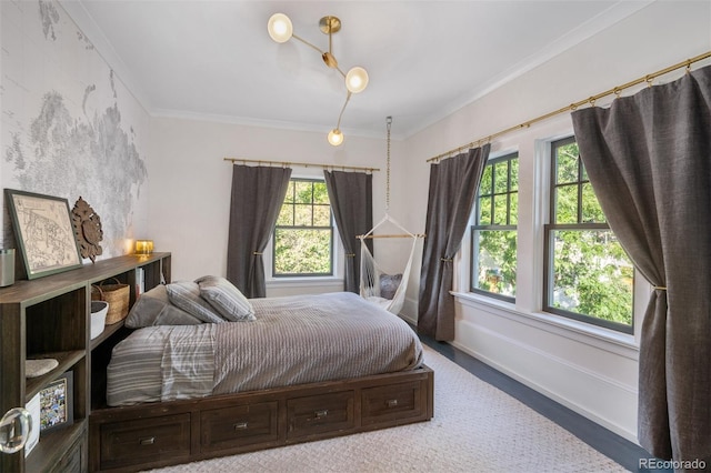 bedroom with ornamental molding and multiple windows