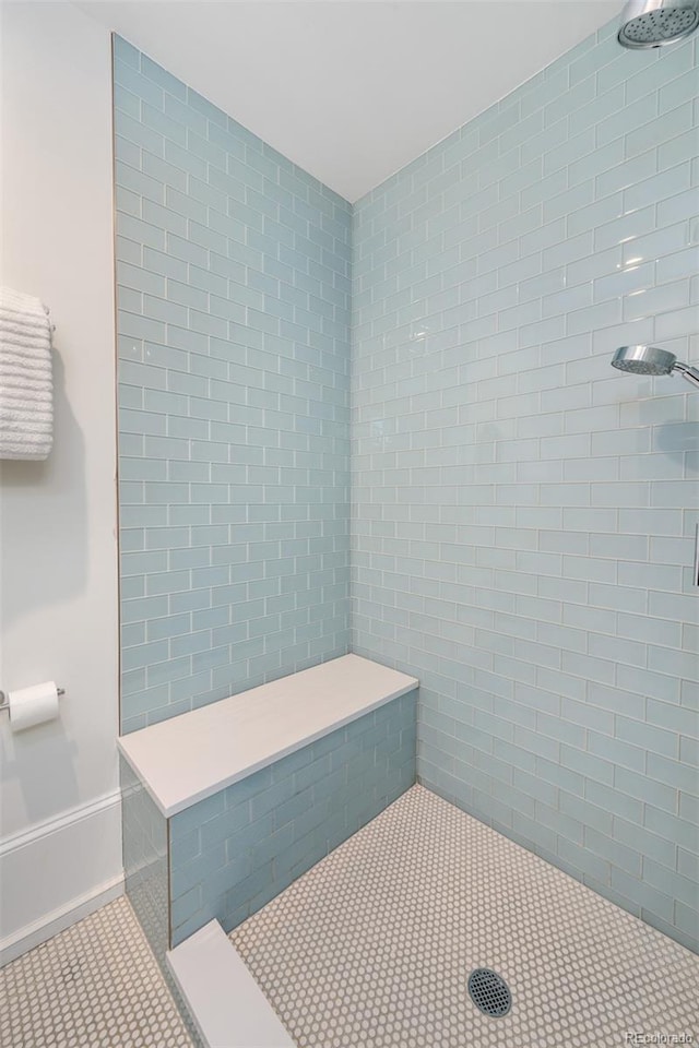 bathroom featuring tile patterned flooring and tiled shower