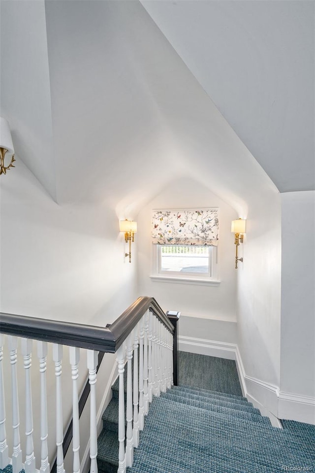 stairs featuring carpet and vaulted ceiling