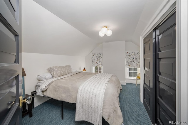 carpeted bedroom with vaulted ceiling