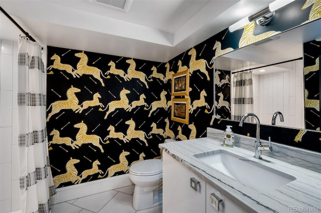 bathroom featuring walk in shower, vanity, toilet, and tile patterned floors