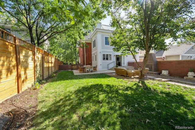 rear view of house with a lawn and a patio area