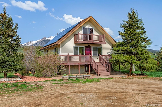 301 Lagoon Ln, Silverthorne, CO 80498 - view of front of property with a balcony, a deck with mountain view, and roof mounted solar panels