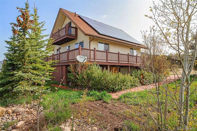 301 Lagoon Ln, Silverthorne, CO 80498 - back of property with a balcony, solar panels, and a wooden deck