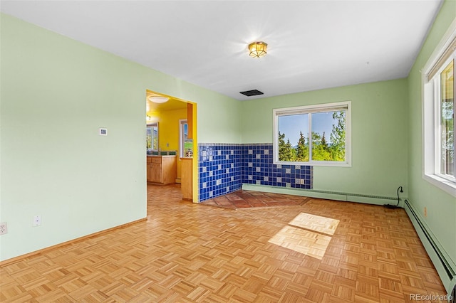 301 Lagoon Ln, Silverthorne, CO 80498 - empty room featuring a baseboard heating unit, a wainscoted wall, and baseboards