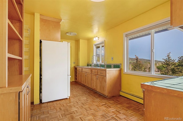 301 Lagoon Ln, Silverthorne, CO 80498 - kitchen featuring freestanding refrigerator, a baseboard heating unit, a sink, and light countertops