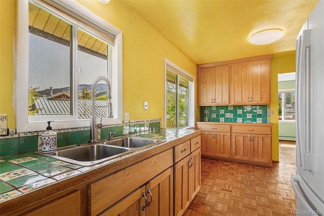 301 Lagoon Ln, Silverthorne, CO 80498 - kitchen featuring a sink, healthy amount of natural light, a baseboard radiator, and tile countertops