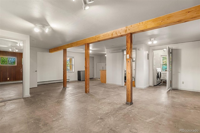 301 Lagoon Ln, Silverthorne, CO 80498 - below grade area featuring a baseboard radiator, a baseboard heating unit, washer and clothes dryer, and baseboards