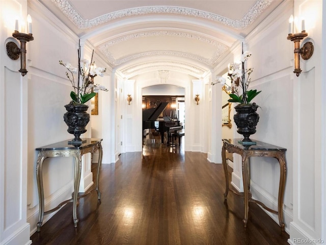 hallway featuring dark wood-type flooring and vaulted ceiling