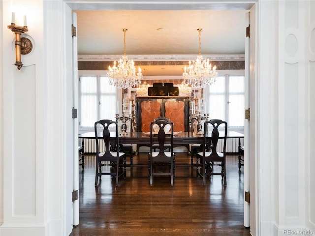 dining room featuring plenty of natural light, an inviting chandelier, and dark hardwood / wood-style flooring