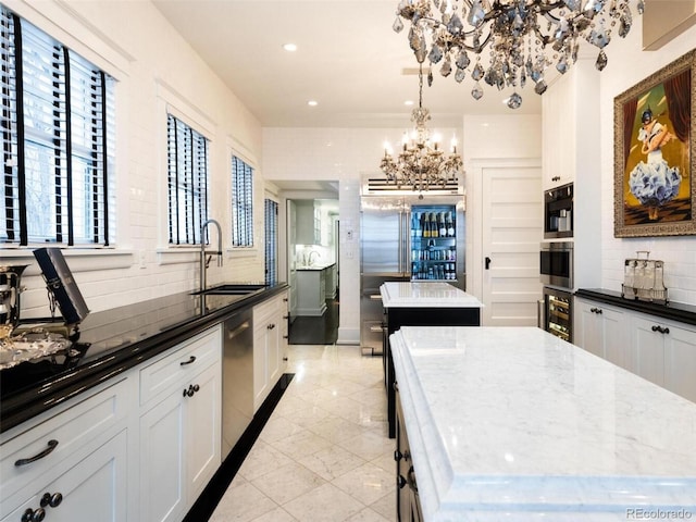 kitchen with a kitchen island, sink, decorative backsplash, and dark stone counters