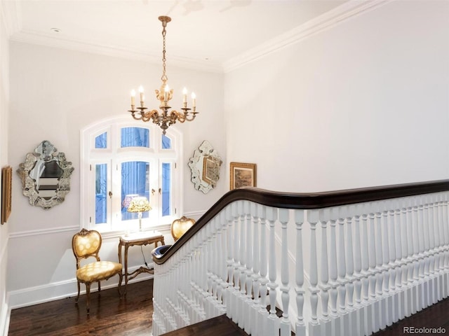 interior space featuring a notable chandelier, hardwood / wood-style flooring, and ornamental molding