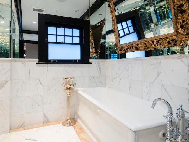 bathroom featuring tile walls and a tub