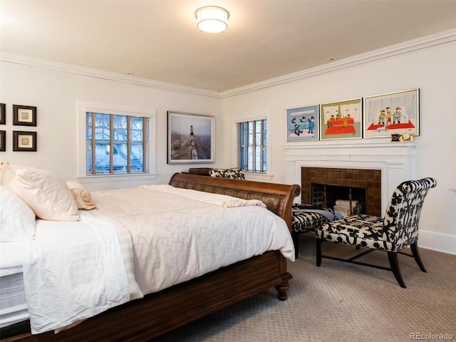 bedroom featuring crown molding, carpet flooring, and a tile fireplace