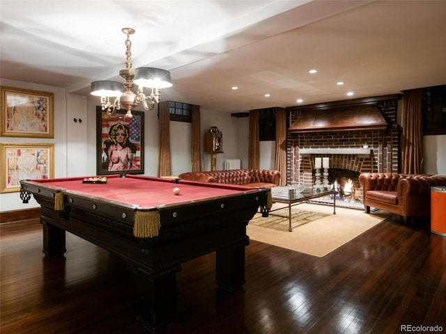 game room featuring a brick fireplace, wood-type flooring, billiards, and radiator