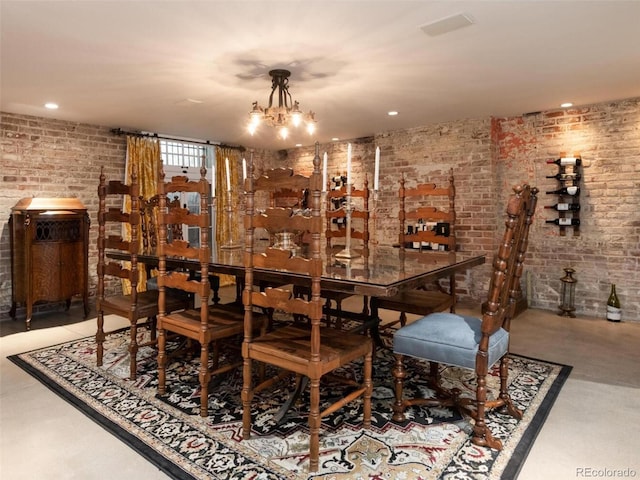 bar featuring brick wall, pendant lighting, and a notable chandelier