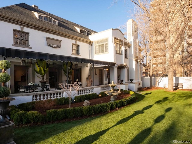 back of house with a patio and a yard