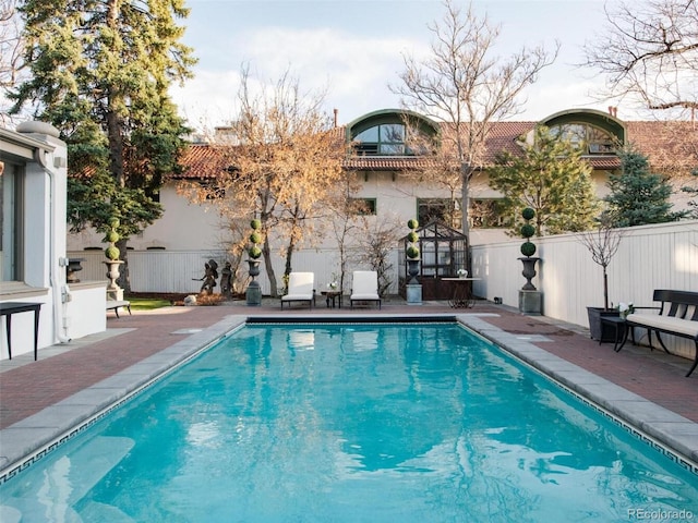 view of swimming pool with a patio area