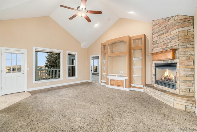 unfurnished living room with built in shelves, ceiling fan, a fireplace, and light carpet