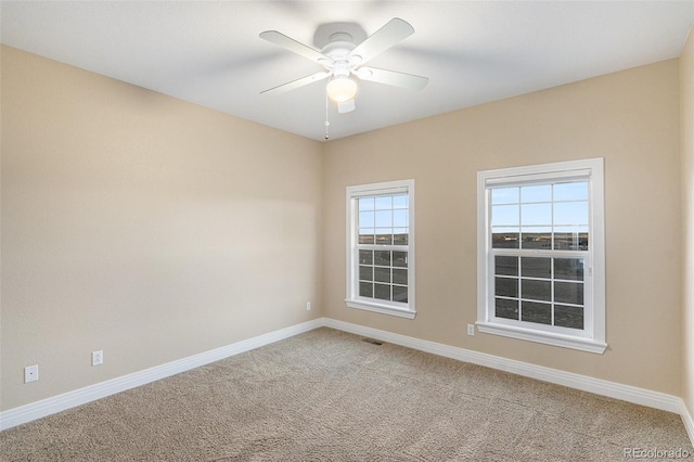 unfurnished room with ceiling fan and carpet floors