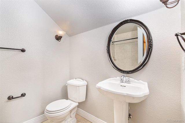 bathroom featuring a textured ceiling and toilet