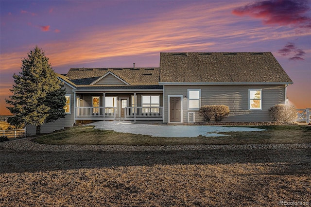 back house at dusk with a patio