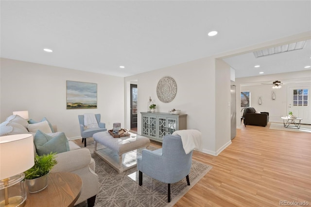 living room featuring ceiling fan and light wood-type flooring