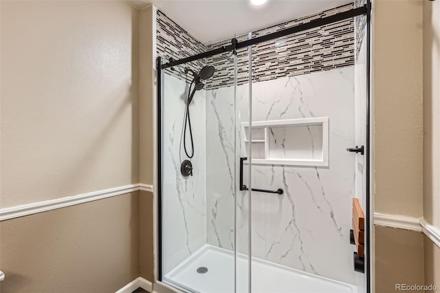 full bathroom with a marble finish shower