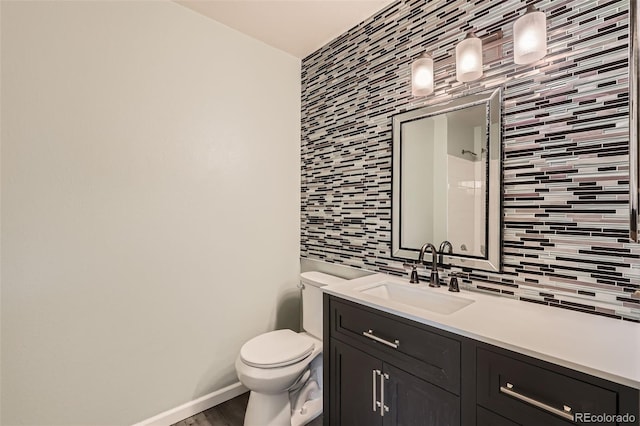 bathroom with tile walls, toilet, vanity, decorative backsplash, and wood finished floors