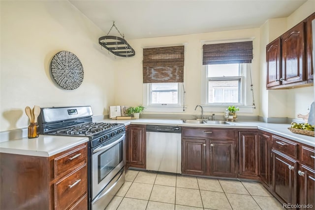 3024 W Denver Pl, Denver, CO 80211 - kitchen featuring appliances with stainless steel finishes, a sink, light countertops, and light tile patterned flooring