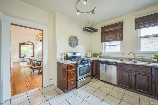 3024 W Denver Pl, Denver, CO 80211 - kitchen featuring stainless steel appliances, a sink, a chandelier, and plenty of natural light