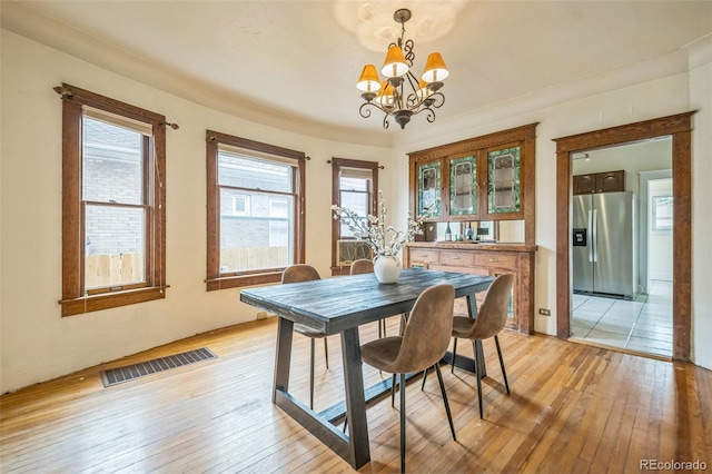 3024 W Denver Pl, Denver, CO 80211 - dining space featuring a chandelier and light wood-style floors