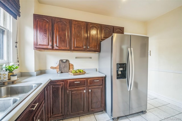 3024 W Denver Pl, Denver, CO 80211 - kitchen with stainless steel refrigerator with ice dispenser, light countertops, light tile patterned floors, and plenty of natural light