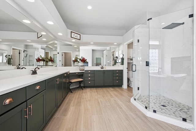 full bathroom with toilet, recessed lighting, wood finished floors, a shower stall, and vanity
